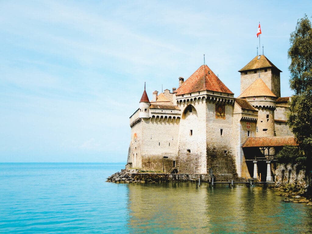 The Chillon Castle on Lake Geneva. A visit to Switzerland will have you feeling you just walked into The Sound of Music. Here are some sights and landmarks you absolutely shouldn't miss. And for more travel tips and wanderlust inspiration follow The Scenic Suitcase on Pinterest!