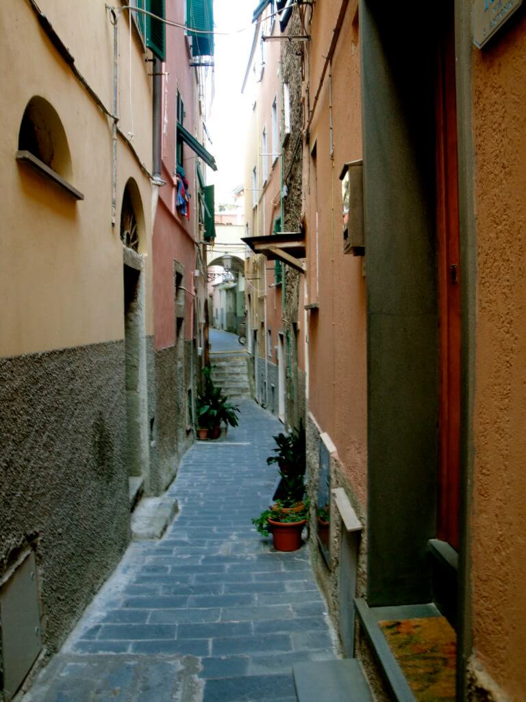 A narrow alleyway in Cinque Terre. Discover 15 picture perfect reasons to visit Italy. And for more travel tips and wanderlust inspiration follow The Scenic Suitcase on Pinterest!