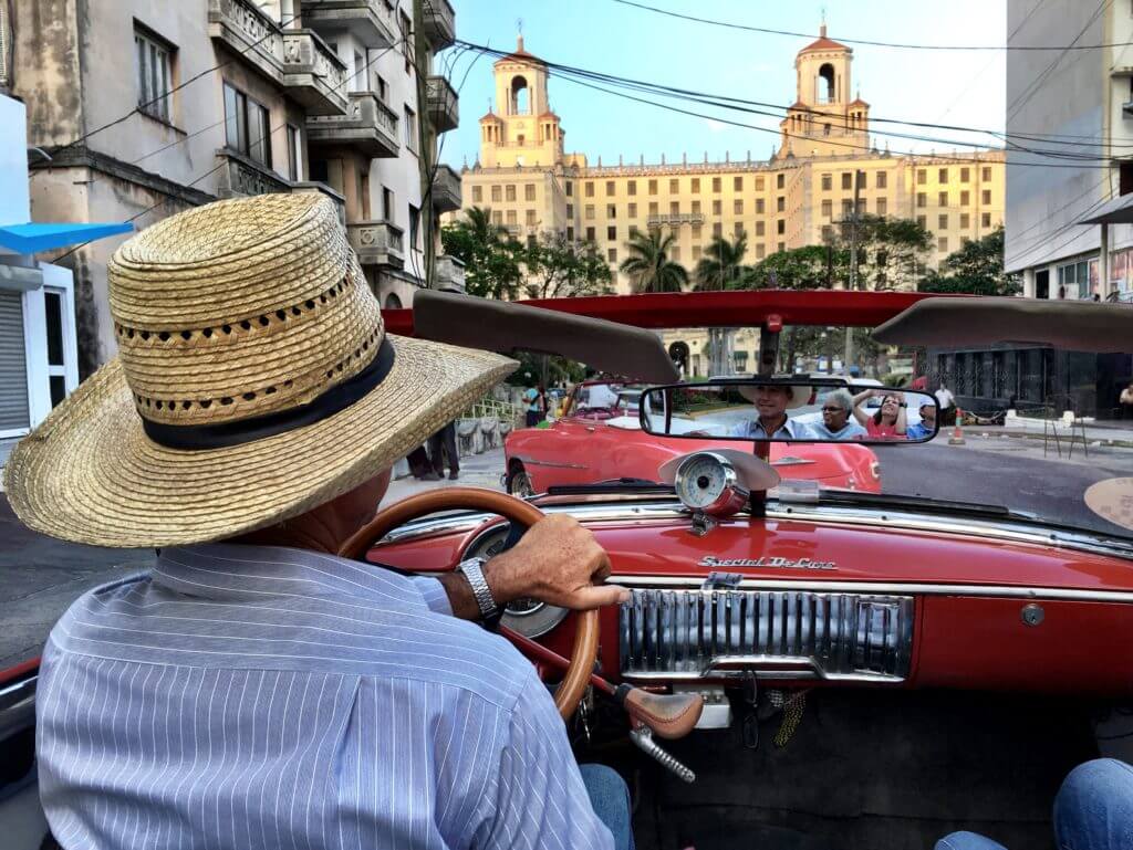 Riding in the back of a red convertible in Havana. Discover picture perfect reasons to visit Cuba. Find out why it's become such a popular travel destination, and what you shouldn't miss when you're there! And for more travel tips and wanderlust inspiration follow The Scenic Suitcase on Pinterest!