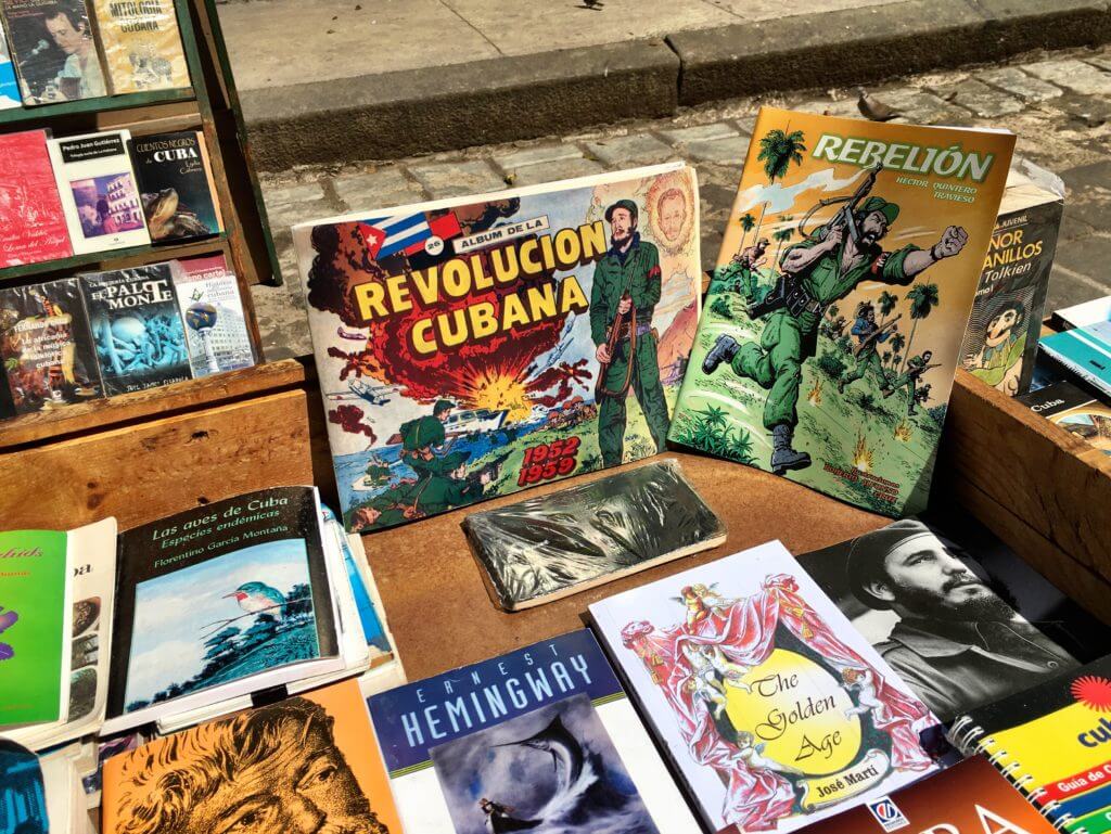 Books about the Cuban Revolution and Hemingway in a Havana antique market. Discover picture perfect reasons to visit Cuba. Find out why it's become such a popular travel destination, and what you shouldn't miss when you're there! And for more travel tips and wanderlust inspiration follow The Scenic Suitcase on Pinterest!