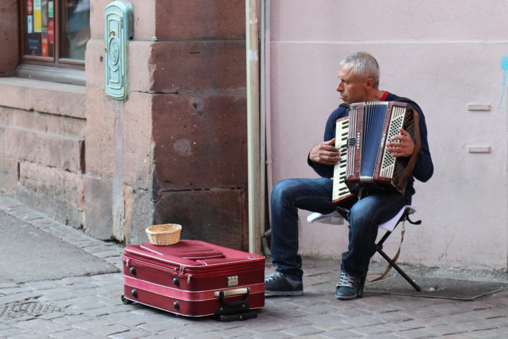 An accordion player. Discover 10 picture perfect reasons to visit Colmar, France. And for more travel tips and wanderlust inspiration follow The Scenic Suitcase on Pinterest!