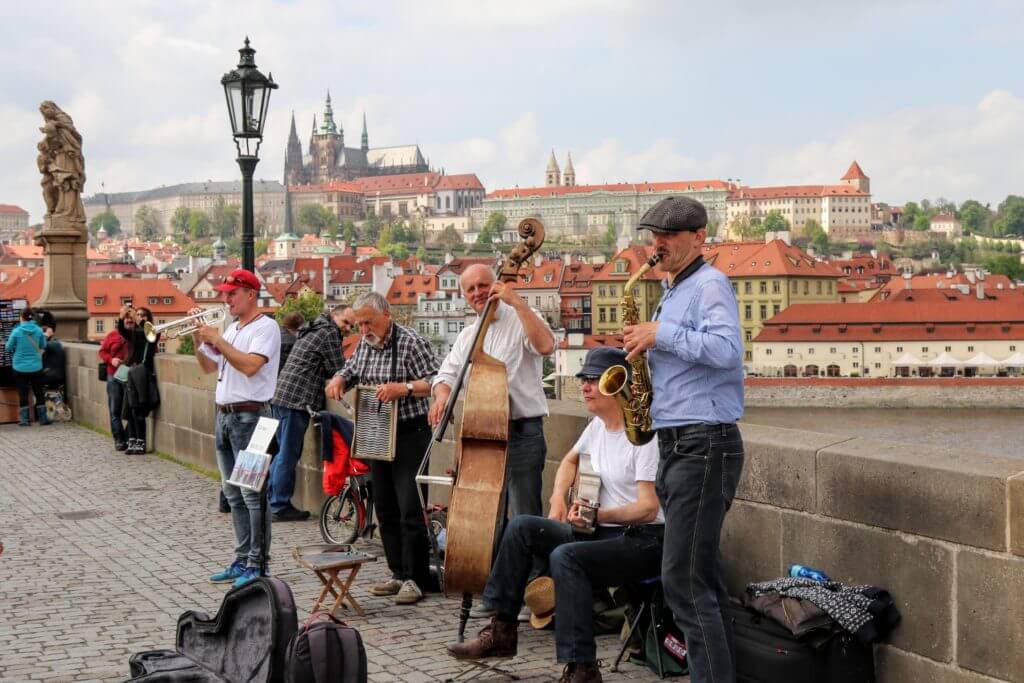 Musicians playing on the Saint Charles Bridge. Discover 25 picture perfect reasons to visit Prague, Czech Republic. Want even more wanderlust inspiration? Follow The Scenic Suitcase on Pinterest!