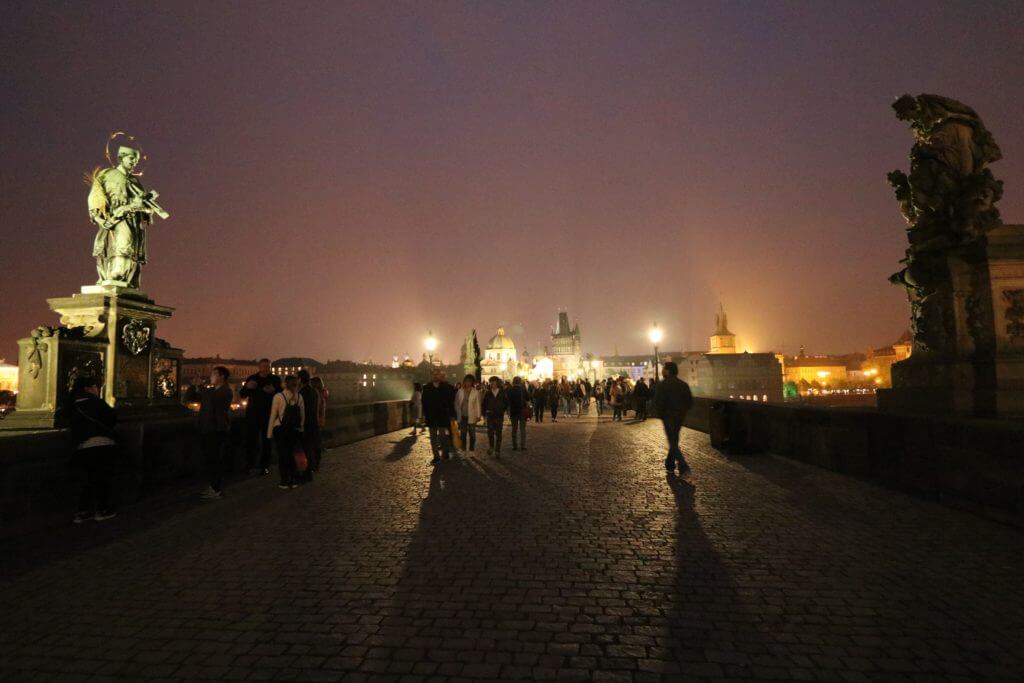 An evening walk across the Saint Charles Bridge. Discover 25 picture perfect reasons to visit Prague, Czech Republic. Want even more wanderlust inspiration? Follow The Scenic Suitcase on Pinterest!
