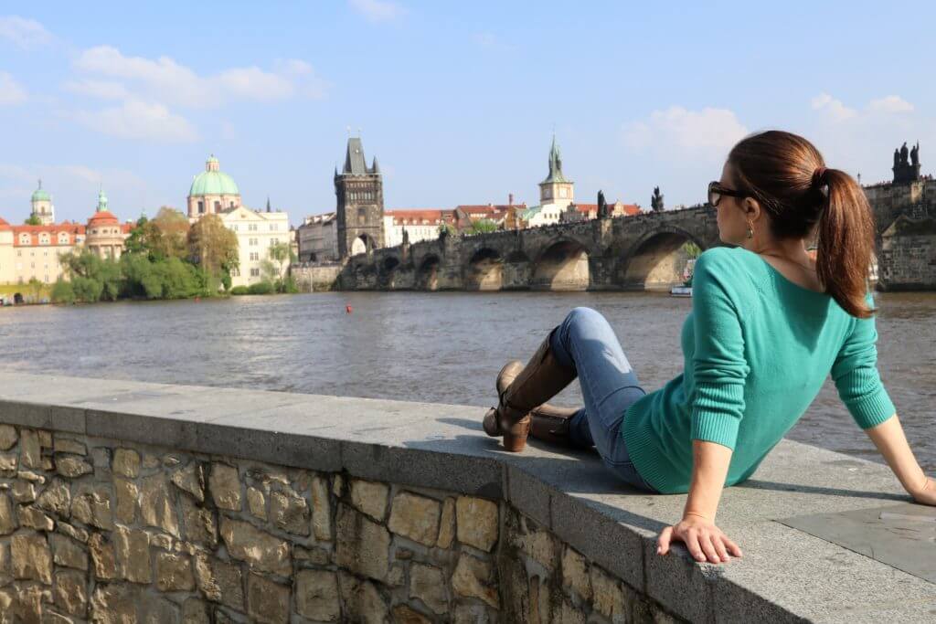 Lounging with a view of the river and the Saint Charles Bridge. Discover 25 picture perfect reasons to visit Prague, Czech Republic. Want even more wanderlust inspiration? Follow The Scenic Suitcase on Pinterest!