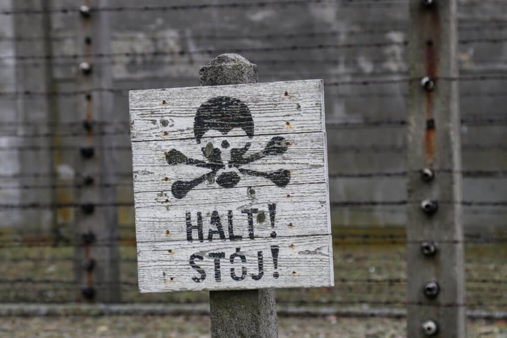 A skull and crossbones warning on the fence of Auschwitz. The two most famous concentration camps in WWII - Auschwitz I & Auschwitz-Birkenau. Please note, this post contains graphic material. Discretion is advised. And for more travel tips and wanderlust inspiration follow The Scenic Suitcase on Pinterest!