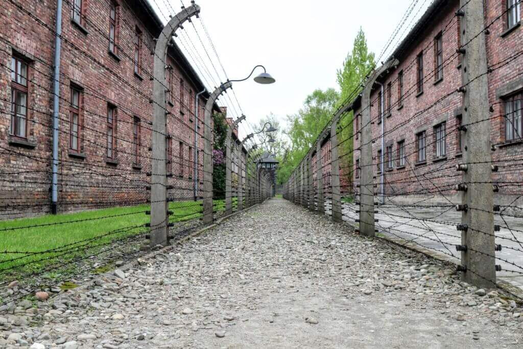 Barbed wire fences by dorm blocks in Auschwitz. The two most famous concentration camps in WWII - Auschwitz I & Auschwitz-Birkenau. Please note, this post contains graphic material. Discretion is advised. And for more travel tips and wanderlust inspiration follow The Scenic Suitcase on Pinterest!