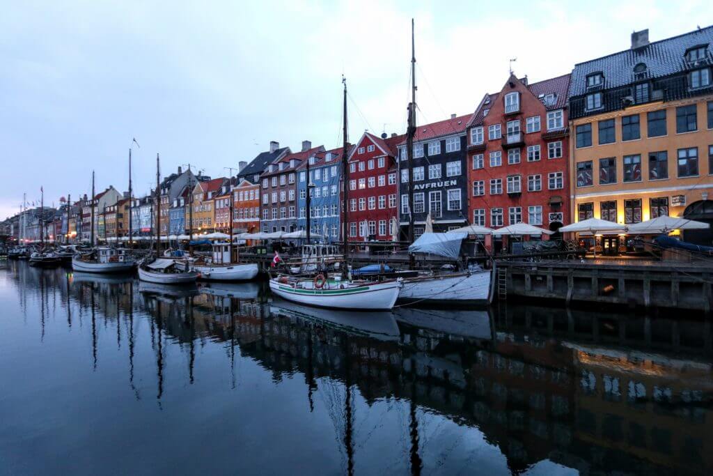 The Nyhavn Canal at sunrise. Discover 12 picture perfect reasons to visit Copenhagen, Denmark. Want even more wanderlust inspiration? Follow The Scenic Suitcase on Pinterest!