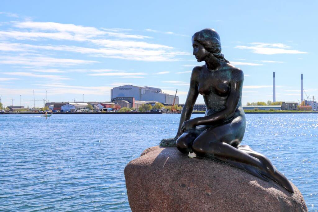 The Littler Mermaid statue along the waterfront. Discover 12 picture perfect reasons to visit Copenhagen, Denmark. Want even more wanderlust inspiration? Follow The Scenic Suitcase on Pinterest!