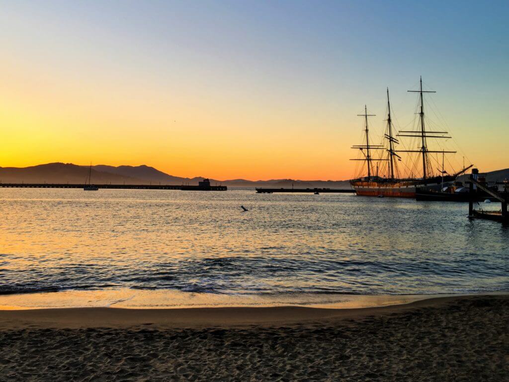 A ship at sunset in the San Francisco Bay. San Francisco is a gem among California's coastal cities. Discover 15 picture perfect reasons why you should plan a trip to the City by the Bay. For more travel tips and wanderlust inspiration follow The Scenic Suitcase on Pinterest!