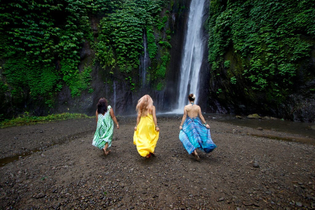 Three brightly colored ladies walking towards Munduk Waterfall. Discover 27 picture perfect things to see in Bali, Indonesia. And for more travel tips and wanderlust inspiration, follow The Scenic Suitcase on Pinterest!