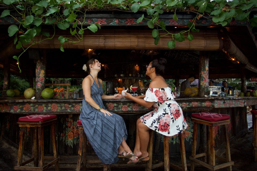 Drinking at a tropical outdoor bar. Find out what it's like to attend The Blonde Abroad blogging retreat in Bali. From detailed coursework, to a beautiful villa, to delicious food and more!