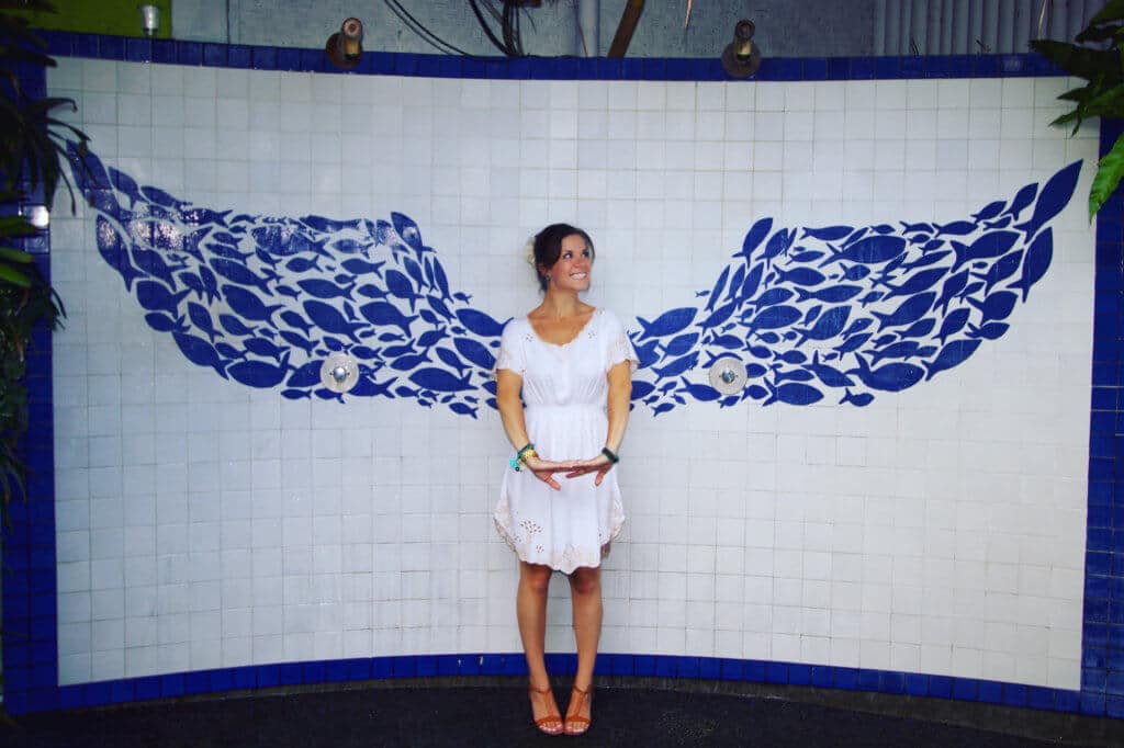 Posing with blue fish angel wings. Find out what it's like to attend The Blonde Abroad blogging retreat in Bali. From detailed coursework, to a beautiful villa, to delicious food and more!