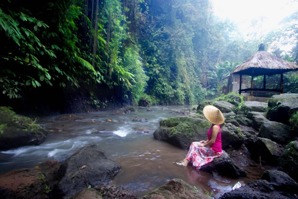 Enjoying a zen moment downstream from a waterfall. Find out what it's like to attend The Blonde Abroad blogging retreat in Bali. From detailed coursework, to a beautiful villa, to delicious food and more!