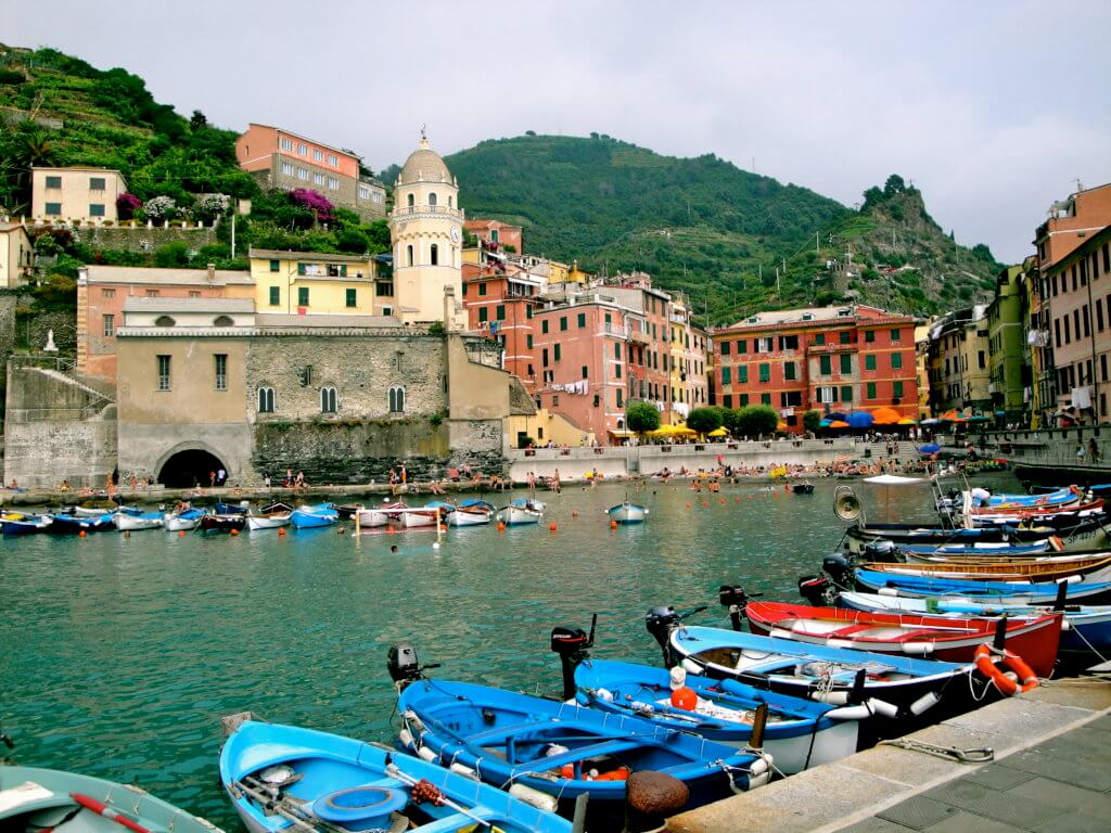 Colorful boats in the Vernazza cove. Discover 5 of Europe's most charming villages! And for more travel tips and wanderlust inspiration, follow The Scenic Suitcase on Pinterest!