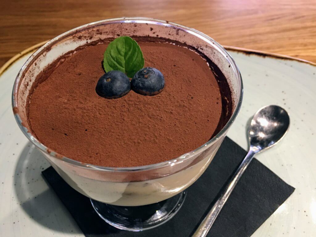 A delicious tiramisu with blueberries. Just one of the many reasons to visit Krakow, Poland. For more travel tips and wanderlust inspiration follow The Scenic Suitcase on Pinterest!