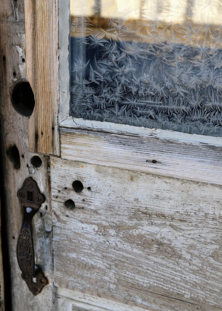 Frost on the window pane of an old wooden door. Discover 22 picture perfect reasons to visit Bozeman, Montana. And for more travel tips and wanderlust inspiration follow The Scenic Suitcase on Pinterest!
