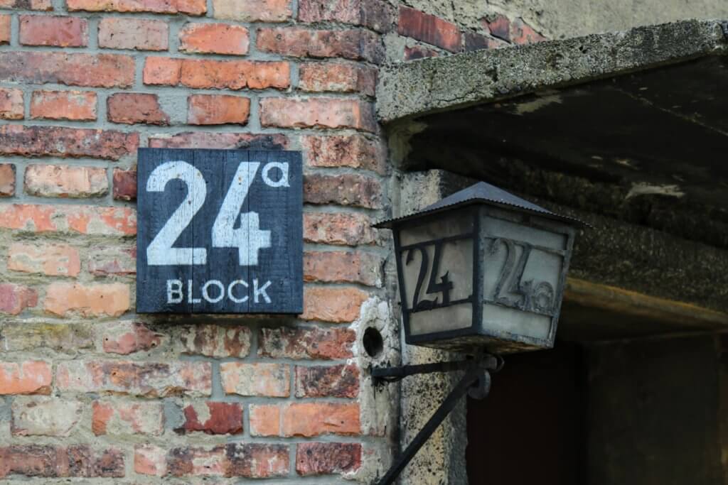A sign outside the Block 24 building in Auschwitz. Learning about the history of this terrible concentration camp is just one of the many reasons to visit Krakow, Poland. For more travel tips and wanderlust inspiration follow The Scenic Suitcase on Pinterest!