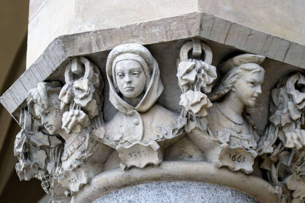 Sculpted heads on a statue in the main market square. Just one of the many reasons to visit Krakow, Poland. For more travel tips and wanderlust inspiration follow The Scenic Suitcase on Pinterest!