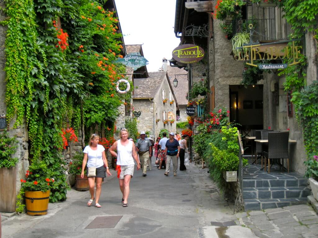 A picturesque street in Yvoire, France. Discover 5 of Europe's most charming villages! And for more travel tips and wanderlust inspiration, follow The Scenic Suitcase on Pinterest!