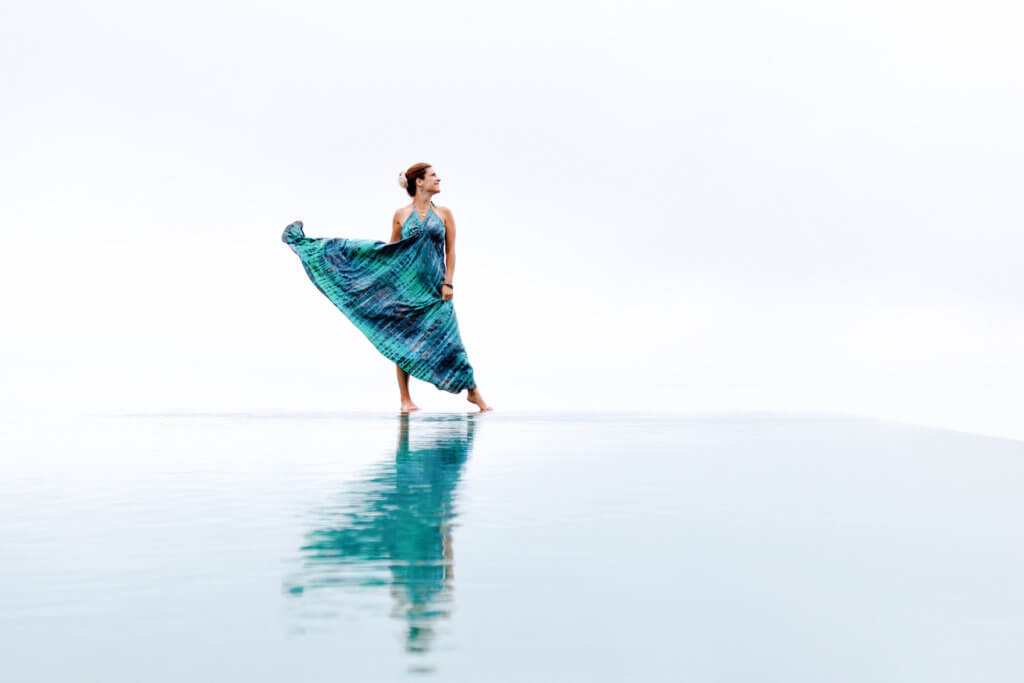 Dancing in a blue dress at the Munduk Moding Plantation's infinity pool in Bali, Indonesia. Discover the most picture perfect moments of the year. And for more travel tips and wanderlust inspiration, follow The Scenic Suitcase on Pinterest!