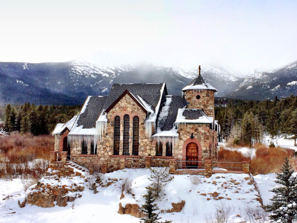 Icycles hanging from the snowy Chapel on the Rock outside Estes Park, Colorado. Discover the most picture perfect moments of the year. And for more travel tips and wanderlust inspiration, follow The Scenic Suitcase on Pinterest!