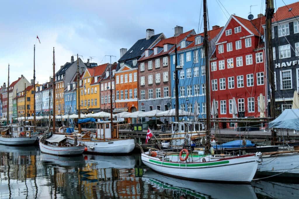 The colorful buildings along the Nyhavn Canal in Copenhagen, Denmark at sunrise. Discover the most picture perfect moments of the year. And for more travel tips and wanderlust inspiration, follow The Scenic Suitcase on Pinterest!
