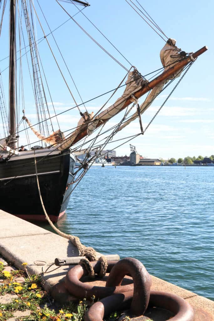 The mast and furrowed sailes of a classic ship anchored along the waterfront of Copenhagen, Denmark. Discover the most picture perfect moments of the year. And for more travel tips and wanderlust inspiration, follow The Scenic Suitcase on Pinterest!