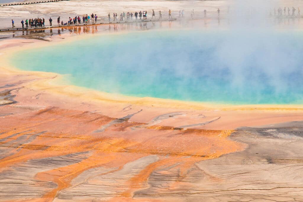 The orange, green, and blue colors of the Grand Prismatic Spring in Yellowstone National Park, Wyoming. Discover the most picture perfect moments of the year. And for more travel tips and wanderlust inspiration, follow The Scenic Suitcase on Pinterest!