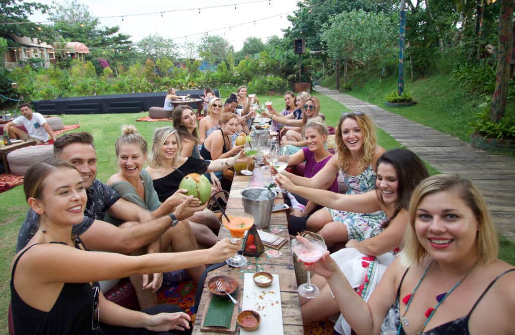A group of us cheersing on the lawn of an outdoor bohemian bar near a wooden boardwalk. There are so many benefits to traveling beyond beautiful pictures and a sun-kissed tan. Find out 7 astonishing ways travel changes you for the better like little else in life can. And for more travel tips and wanderlust inspiration follow The Scenic Suitcase on Pinterest!