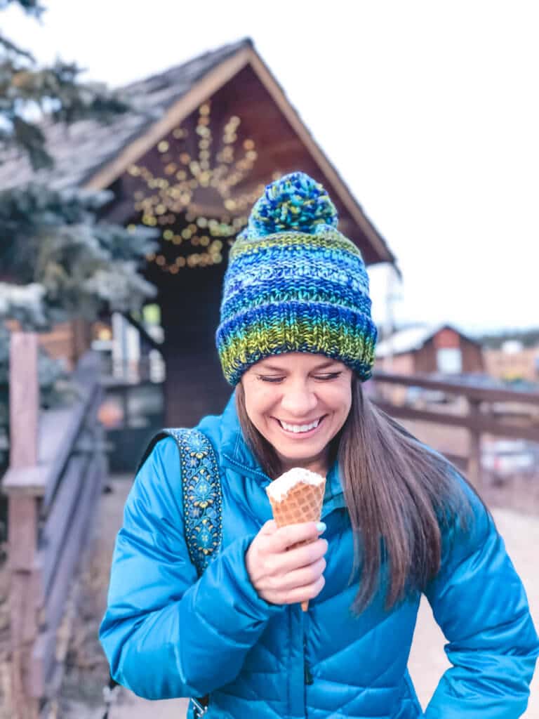 Eating an ice cream cone while wearing a winter hat. Discover 20 picture perfect reasons to visit Colorado in winter. And for more travel tips and wanderlust inspiration follow The Scenic Suitcase on Pinterest!