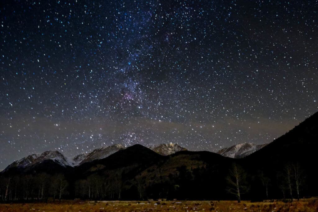 The Milky Way and other stars above snowcapped mountains in Estes Park. Discover 20 picture perfect reasons to visit Colorado in winter. And for more travel tips and wanderlust inspiration follow The Scenic Suitcase on Pinterest!