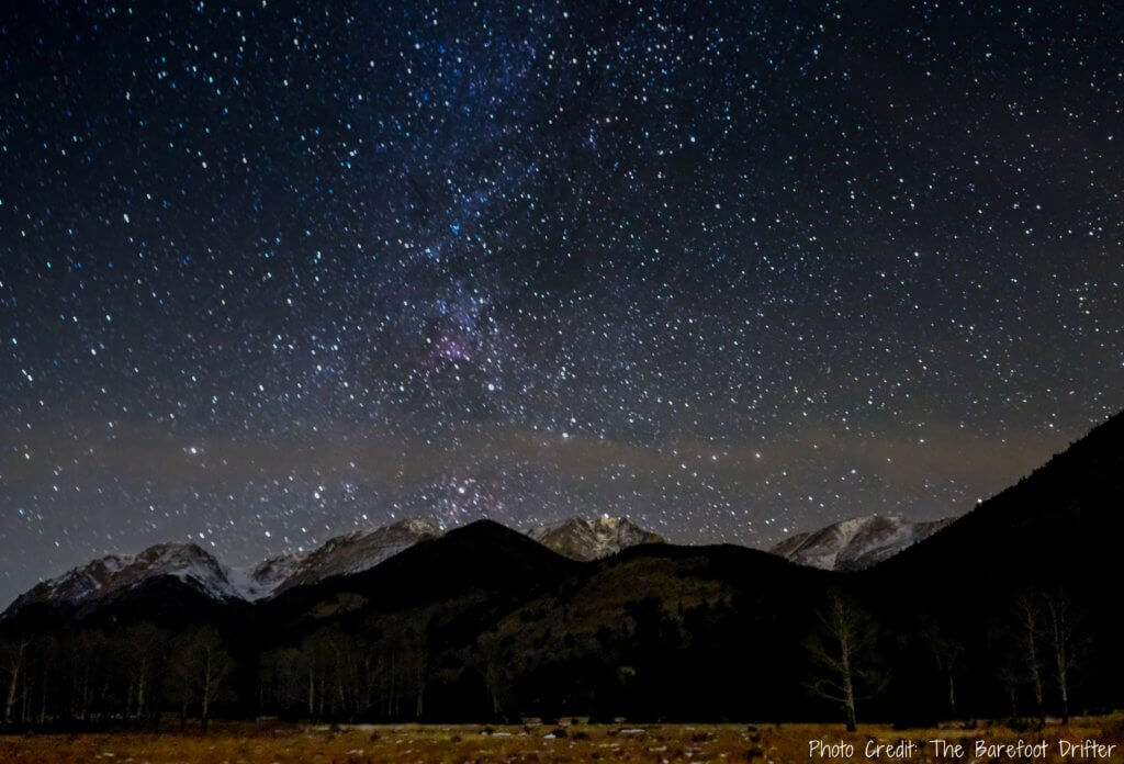 The Milky Way and snow capped moutains at night in Estes Park, Colorado. Discover the most picture perfect moments of the year. And for more travel tips and wanderlust inspiration, follow The Scenic Suitcase on Pinterest!
