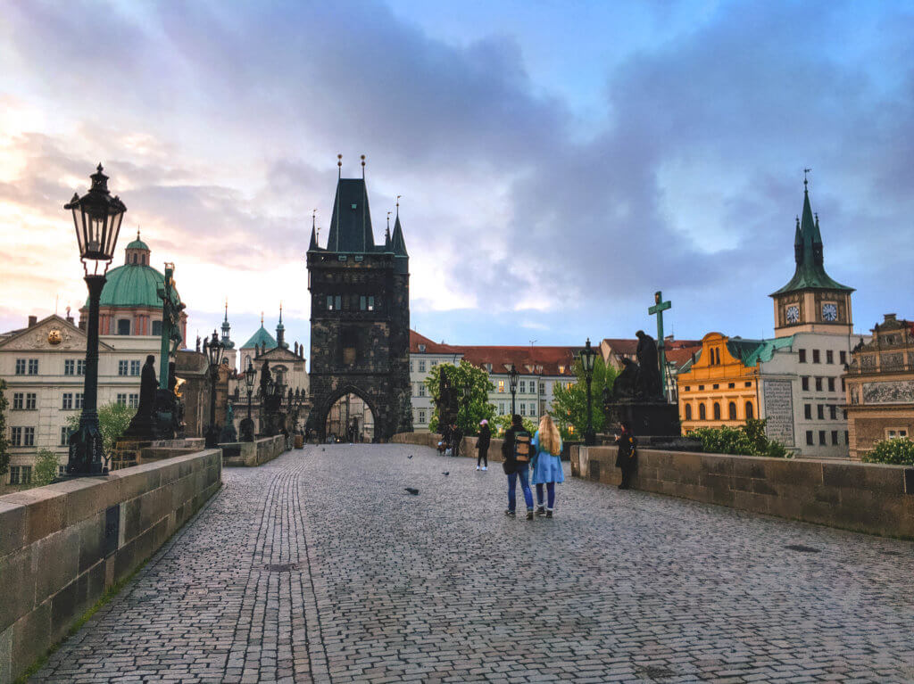 Strolling across the cobblestones of the St. Charles Bridge at sunrise in Prague, Czech Republic. Discover the most picture perfect moments of the year. And for more travel tips and wanderlust inspiration, follow The Scenic Suitcase on Pinterest!