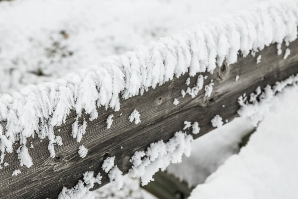 White frost clinging to a fence near the Grand Prismatic Spring in Yellowstone National Park, Wyoming. Discover the most picture perfect moments of the year. And for more travel tips and wanderlust inspiration, follow The Scenic Suitcase on Pinterest!