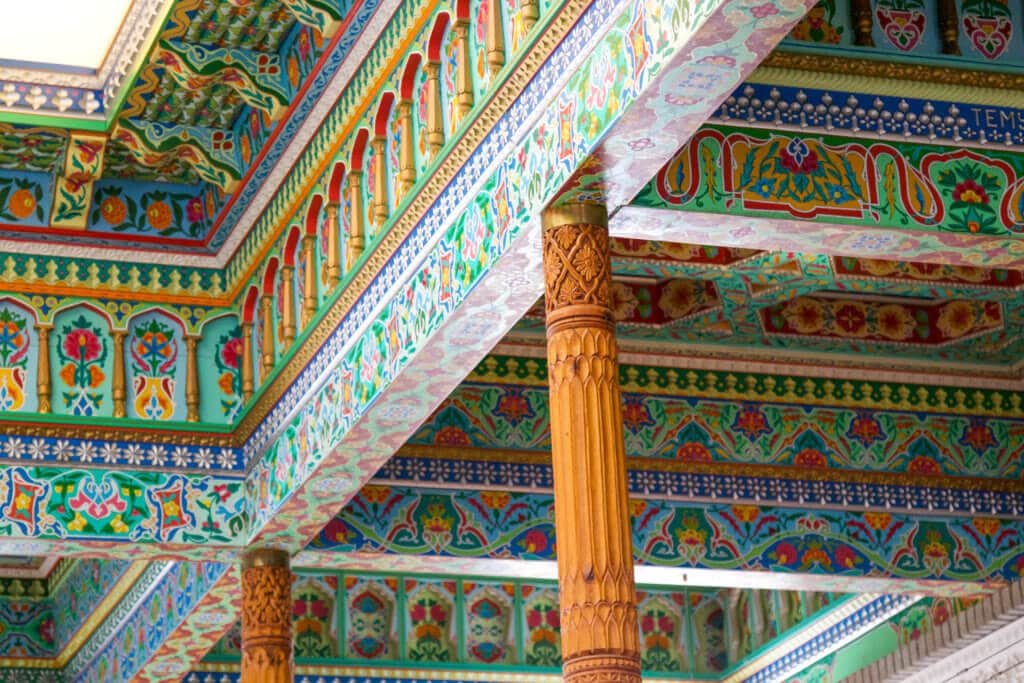 The colorfully painted ceiling and intricately carved pillars in the Boulder Dushanbe Teahouse. Discover the fascinating history and stunning beauty of the Boulder Dushanbe Teahouse. Learn why it's one place in Colorado you simply can't miss! And for more travel tips and wanderlust inpiration follow The Scenic Suitcase on Pinterest!