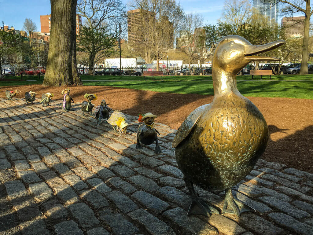Make Way For Ducklings bronze statues on a brick sidewalk. Discover the picture perfect reasons to visit Boston, Massachusetts. From historic landmarks to local favorites, this is what you shouldn't miss on your trip to Beantown. And for more wanderlust inspiration and travel tips follow The Scenic Suitcase on Pinterest!