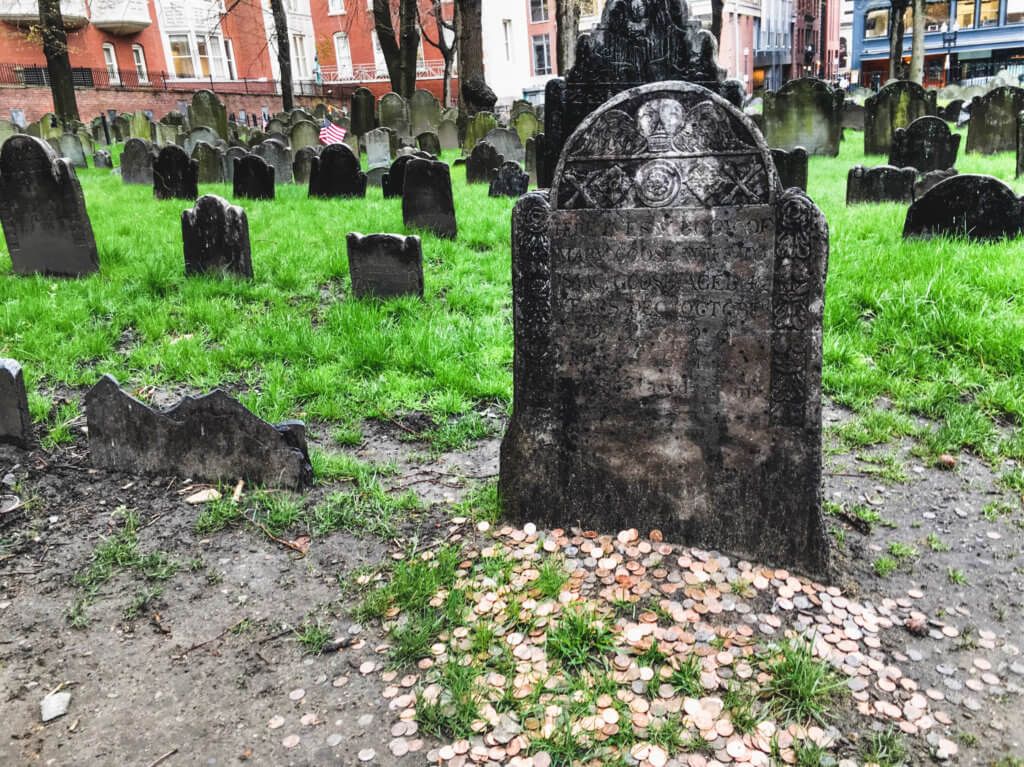 Mother Goose's gravestone with pennies surrounding it. Discover the picture perfect reasons to visit Boston, Massachusetts. From historic landmarks to local favorites, this is what you shouldn't miss on your trip to Beantown. And for more wanderlust inspiration and travel tips follow The Scenic Suitcase on Pinterest!
