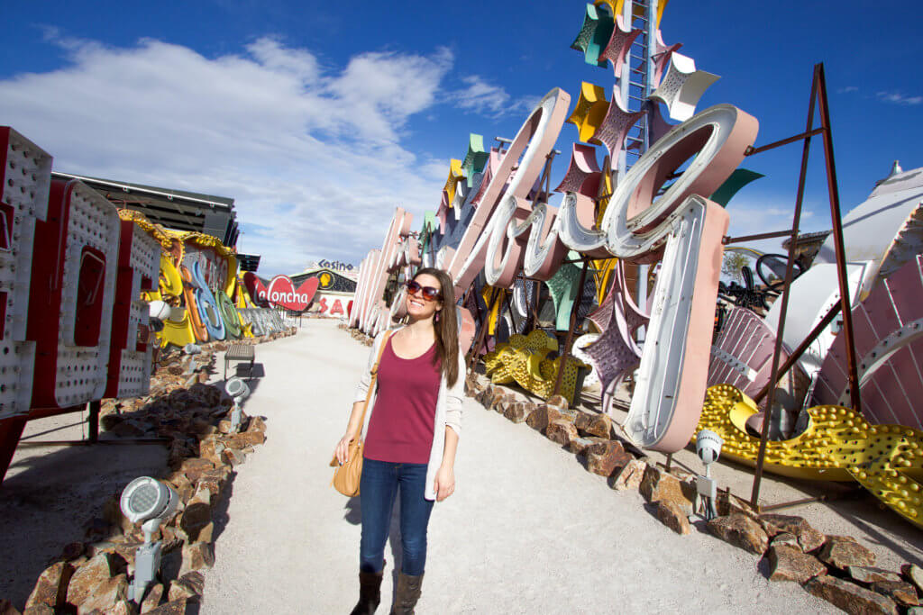 Strolling down the dirt path between large neon signs. Visiting the Neon Boneyard is a must when you're in Las Vegas. Discover the rich history behind these Sin City icons, and what you need to know before you go! And for more travel tips and wanderlust inspiration, follow The Scenic Suitcase on Pinterest!