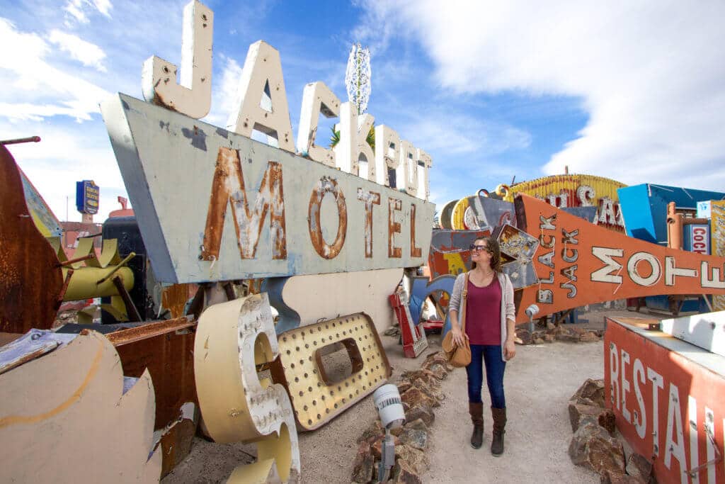 Walking past large vintage neon signs. Visiting the Neon Boneyard is a must when you're in Las Vegas. Discover the rich history behind these Sin City icons, and what you need to know before you go! And for more travel tips and wanderlust inspiration, follow The Scenic Suitcase on Pinterest!