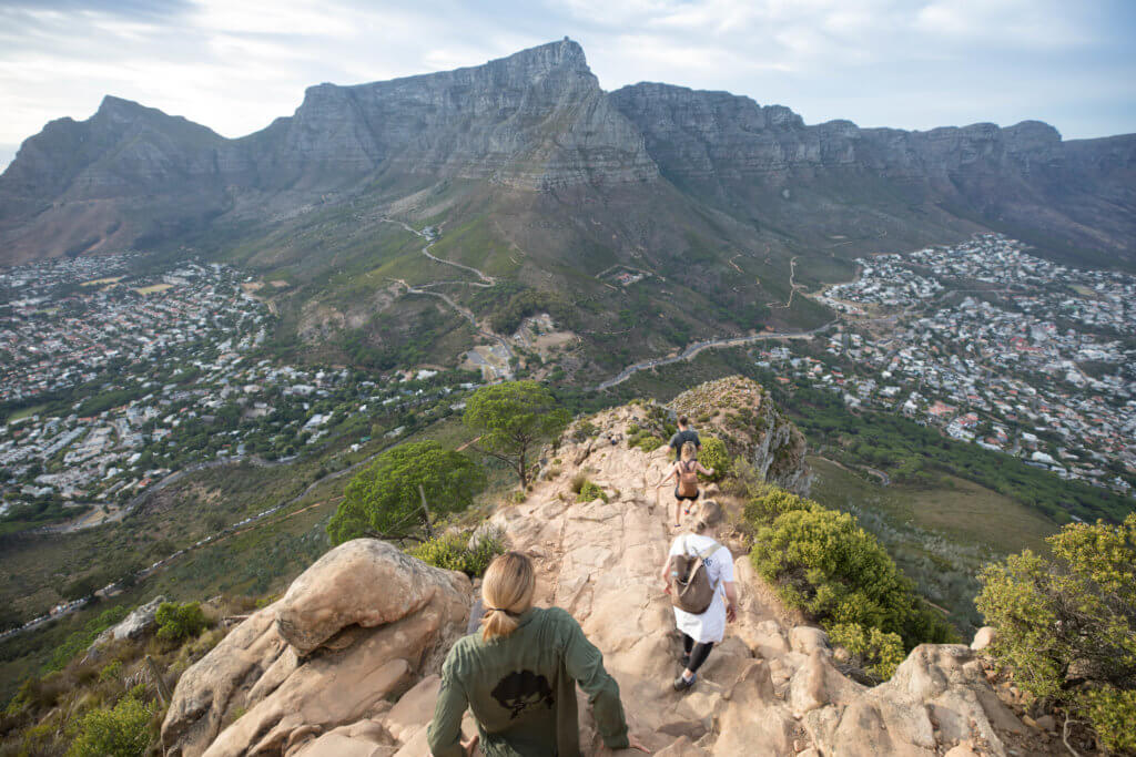 Girls hiking down from the summit of Lionshead in Cape Town. Find out why attending The Blonde Abroad photography tour is a once-in-a-lifetime experience you shouldn't miss. And for more travel tips and wanderlust inspiration, follow The Scenic Suitcase on Pinterest!