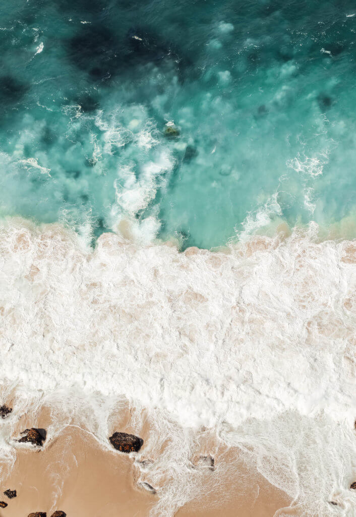 An aerial view of the ocean. There are a million reasons to visit South Africa. The country is as diverse as it is beautiful and offers countless activities and bucket list adventures. Find out what you can't miss! And for more travel tips and wanderlust inspiration follow The Scenic Suitcase on Pinterest!
