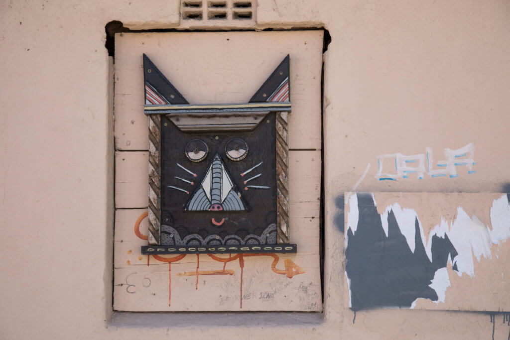 Cat face graffiti. Discover the unique street art of Woodstock in South Africa. Find out the history behind this eclectic district and why it's a must on any visit to Cape Town! And for more travel tips and wanderlust inspiration follow The Scenic Suitcase on Pinterest!