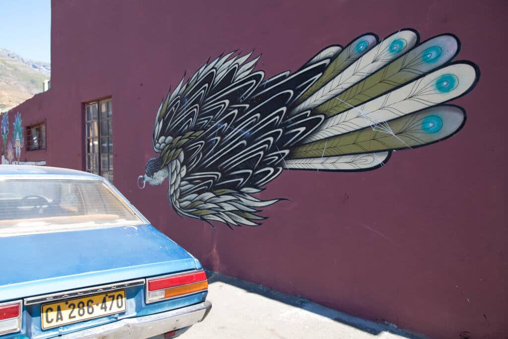 A feathery bird graffiti. Discover the unique street art of Woodstock in South Africa. Find out the history behind this eclectic district and why it's a must on any visit to Cape Town! And for more travel tips and wanderlust inspiration follow The Scenic Suitcase on Pinterest!