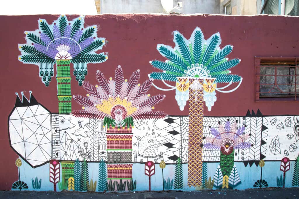 Colorful graffiti plants. Discover the unique street art of Woodstock in South Africa. Find out the history behind this eclectic district and why it's a must on any visit to Cape Town! And for more travel tips and wanderlust inspiration follow The Scenic Suitcase on Pinterest!