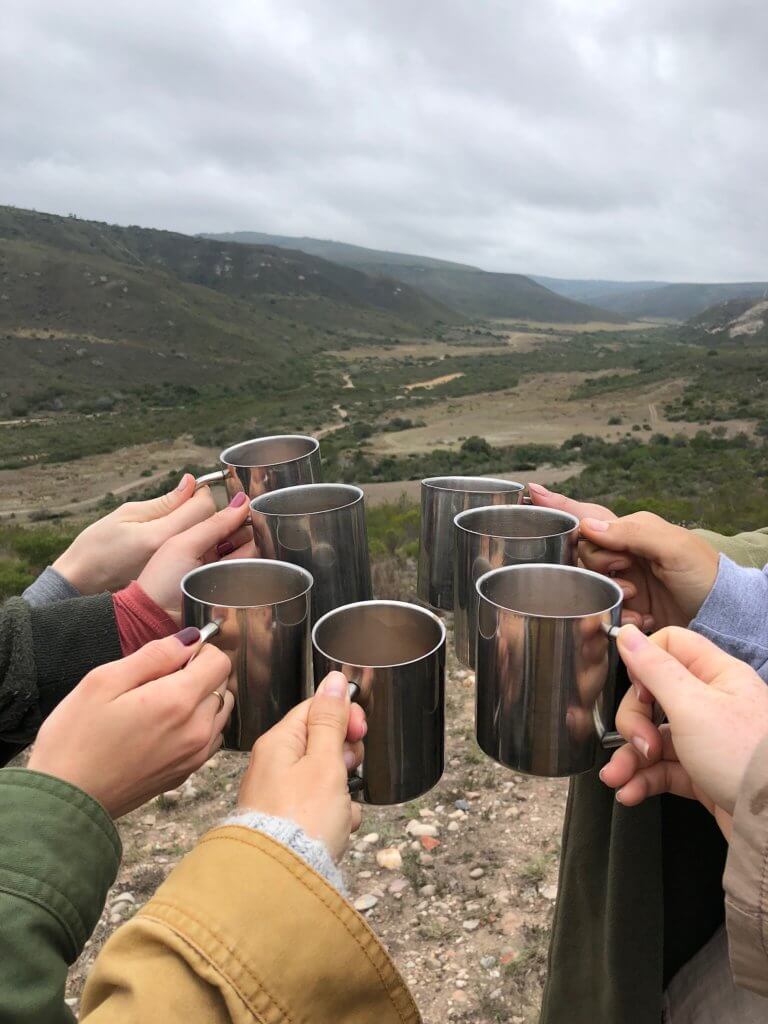 A group of seven cheersing their tin mugs. An African safari at the Gondwana Game Reserve should be at the top of your bucket list! From luxuriously appointed rooms to stunning wildlife, it's an experience everyone should have when visiting South Africa. And for more travel tips and wanderlust inspiration, follow The Scenic Suitcase on Pinterest!