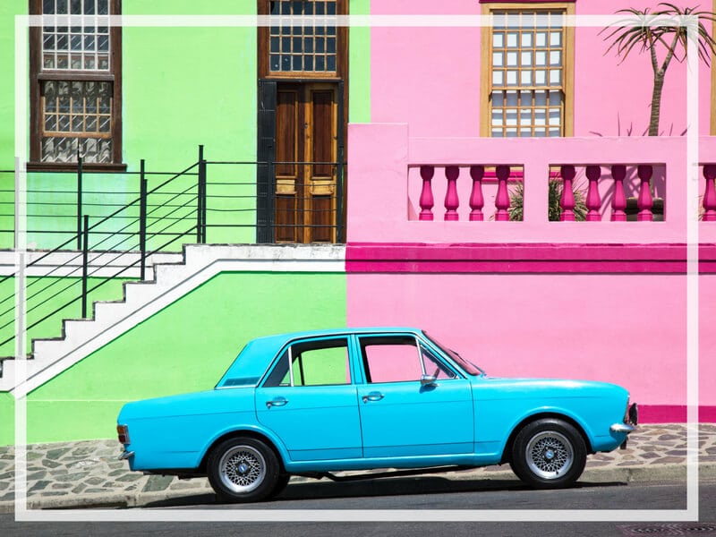 Visiting Bo Kaap in Cape Town feels like stepping into a cartoon. But there's more to the neighborhood than prismatic facades. Discover the colorful history of one of South Africa's most intriguing communities. Plus, get expert tips on what you need to know before you go! And for more travel tips, follow The Scenic Suitcase on Pinterest!