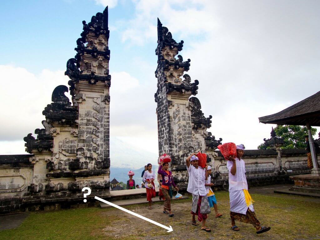 People carrying red packages walking through Heavens Gate at Pura Lempuyang. Using these travel photography composition tips, your images will look just as astounding as the places you visit! Discover all you need to know for jaw-dropping photos! And for more travel tips and wanderlust inspiration follow The Scenic Suitcase on Pinterest!