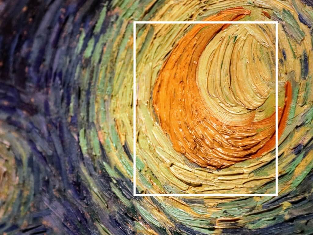 A close-up of the thick brush strokes around the moon of Van Gogh's Starry Night painting. Using these travel photography composition tips, your images will look just as astounding as the places you visit! Discover all you need to know for jaw-dropping photos! And for more travel tips and wanderlust inspiration follow The Scenic Suitcase on Pinterest!