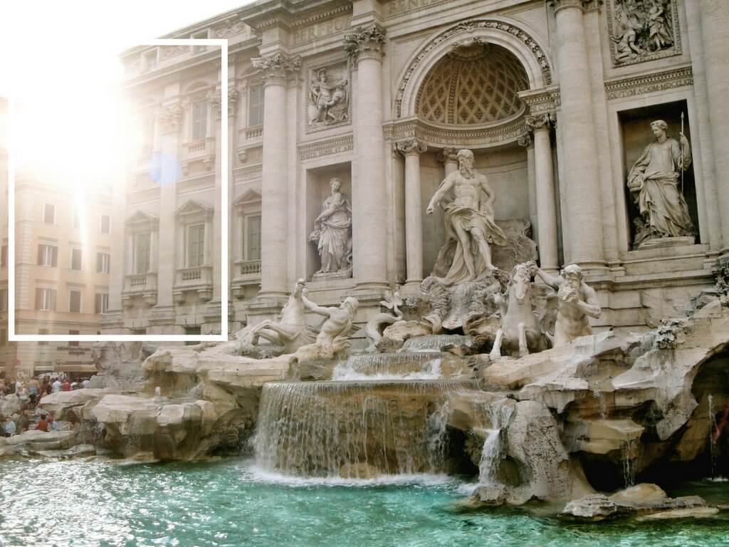 Sunlight coming through the buildings at the Trevi Fountain. Using these travel photography composition tips, your images will look just as astounding as the places you visit! Discover all you need to know for jaw-dropping photos! And for more travel tips and wanderlust inspiration follow The Scenic Suitcase on Pinterest!