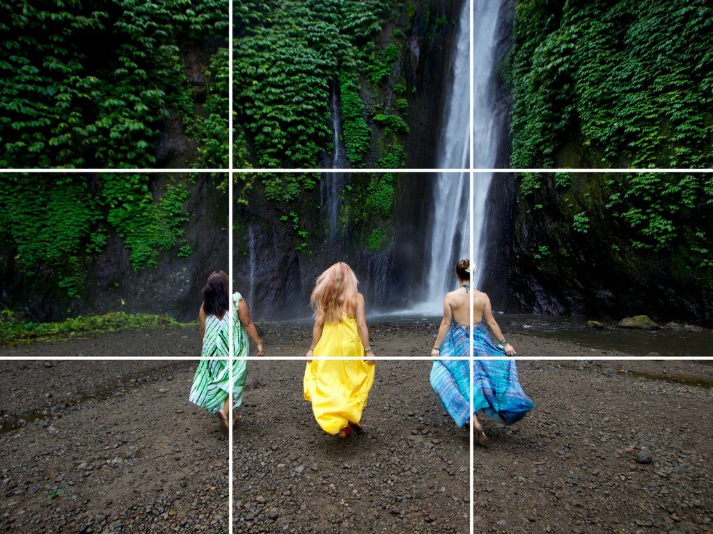 Three girls walking towards a lush waterfall. Using these travel photography composition tips, your images will look just as astounding as the places you visit! Discover all you need to know for jaw-dropping photos! And for more travel tips and wanderlust inspiration follow The Scenic Suitcase on Pinterest!
